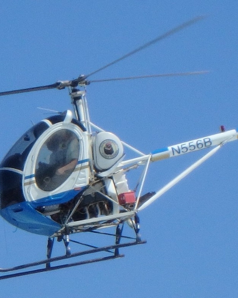 The helicopter in flight against a clear blue sky