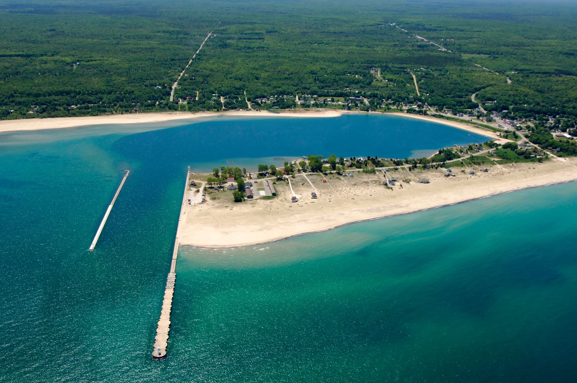 Coast Guard Point from the air: the harbor piers, the sand beach on Lake Superior, Fletchy's on the point and West Bay behind
