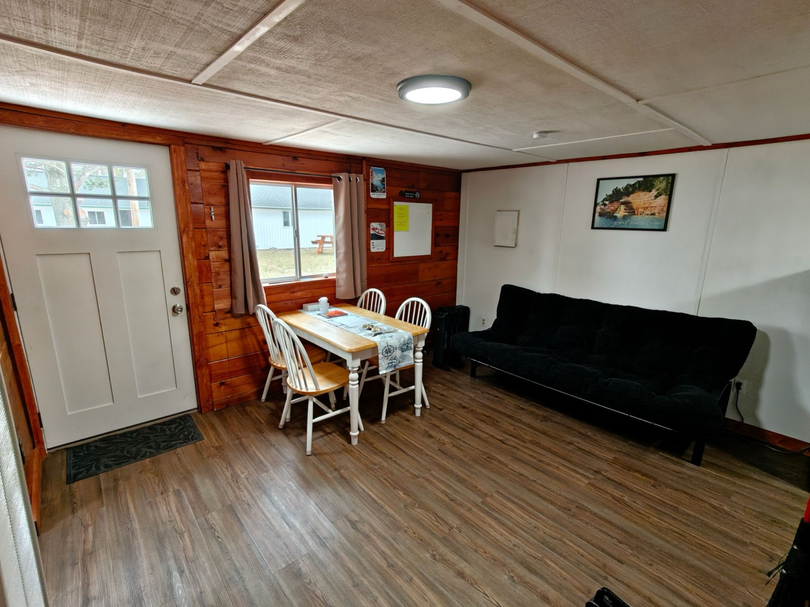 A table for four by the window, the cottage door and a futon